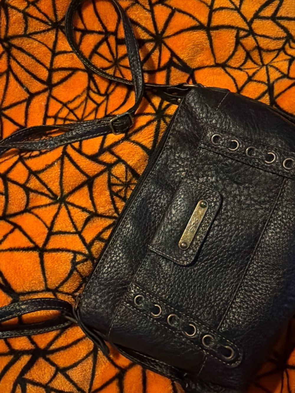 b.o.c. Black Pebbled Leather Crossbody with Grommet Detail